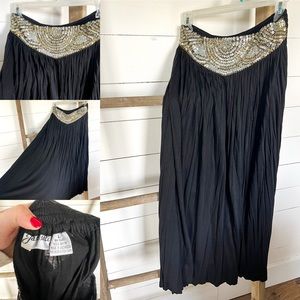 Size large black maxi skirt with beaded embellishment.